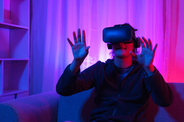 Metaverse technology concept, Man wear VR goggles and have fun to playing games in virtual world