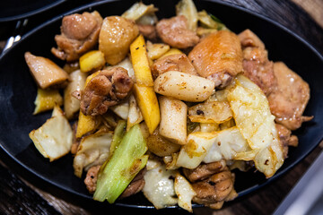 Stir-fried chicken ribs with chicken, cabbage, vegetables, spicy seasoning, and tteokbokki, traditional Korean food