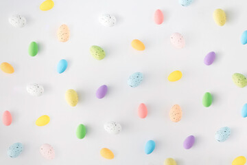 Artificial styrofoam eggs of various colors on white background.