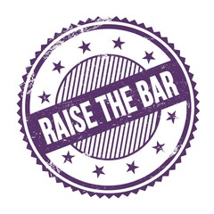 RAISE THE BAR text written on purple indigo grungy round stamp.