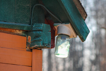 A typical street lamp on the corner of a house	
