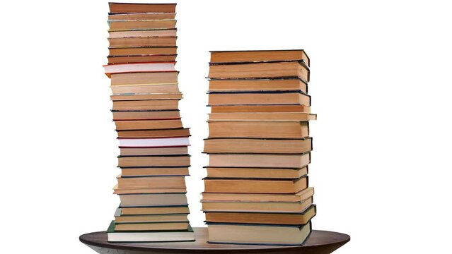 Bale, a pile of books growing on a white background. Teaching and learning science concept. A stack of books on a wooden table, stop motion time laps.