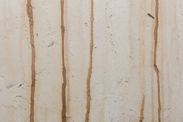 Old dirty concrete white wall with streaks of rusty water weathered background cement obsolete texture