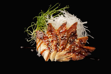 Smoked eel sashimi, daikon, microgreen, unagi sauce, sesame. japanese food on isolated black background, japanese menu.