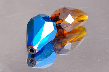 Blue and amber crystal stones isolated on grey background, macro shot of two lapis lazuli energy...