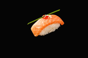 Nigiri sushi cold smoked salmon, chives, sriracha sauce, sesame on isolated black background, japanese menu.