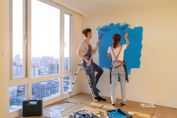 couple painting wall