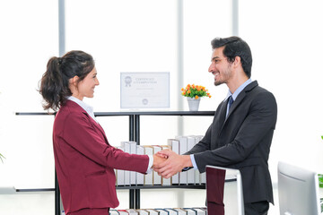 Business men and women shaking hands with joy