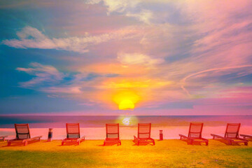 Beach chair with white sand and sky at sunrise