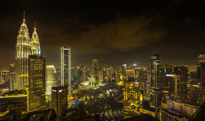 Fototapeta na wymiar Panorama aerial night view of Kuala Lumpur city skyline. Malaysia. Warm mode.