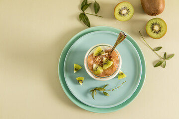 Top view of a modern cup shaped can with a healthy organic fruit smoothie. healthy food. pastel background.