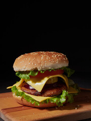 fresh delicious burger on a black background