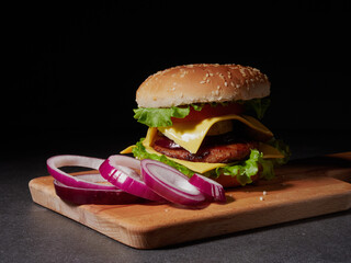 fresh delicious burger on a black background