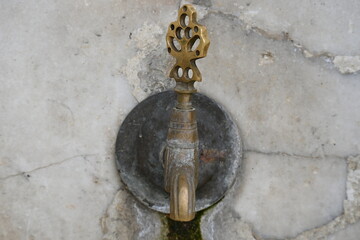 Old faucet on a stone ottoman
