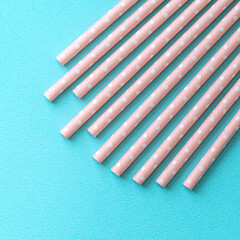 Biodegradable paper straw set on blue table background.