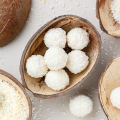 Homemade round candies made of coconut and white chocolate. Preparation of a delicious healthy dessert. Raffaello. Selective focus, top view, square picture