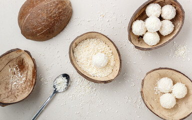 Homemade round candies made of coconut and white chocolate. Preparation of a delicious healthy dessert. Raffaello. Selective focus, top view
