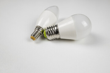 two energy efficient light bulbs on white.