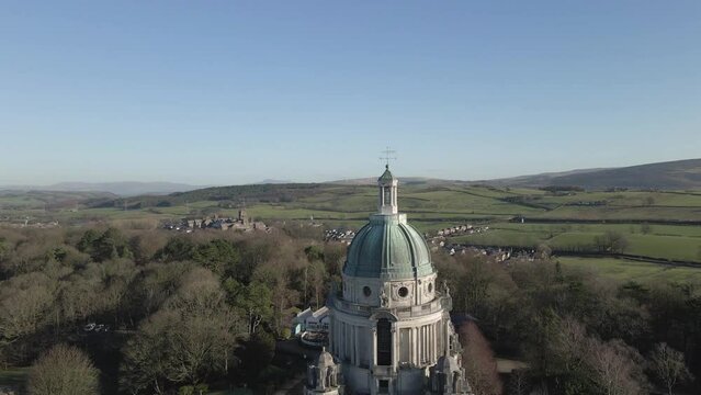 Aerial rising over Ashton Memorial reveals Lancaster countryside, UK