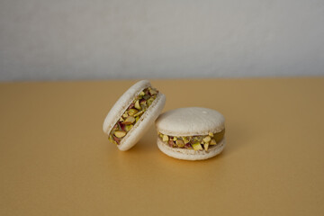 Two macaroons on a yellow background. The sweet dessert is isolated.
