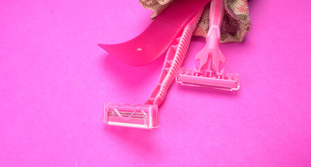 New pink disposable razors for safe shaving of female skin.Razor for smooth shaving. Sharp razors for personal hygienic routine. selective focus.
