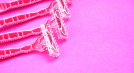 New pink disposable razors for safe shaving of female skin.Razor for smooth shaving. Sharp razors for personal hygienic routine. selective focus.
