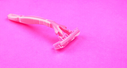 New pink disposable razors for safe shaving of female skin.Razor for smooth shaving. Sharp razors for personal hygienic routine. selective focus.
