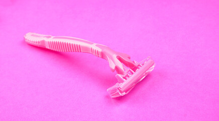 New pink disposable razors for safe shaving of female skin.Razor for smooth shaving. Sharp razors for personal hygienic routine. selective focus.
