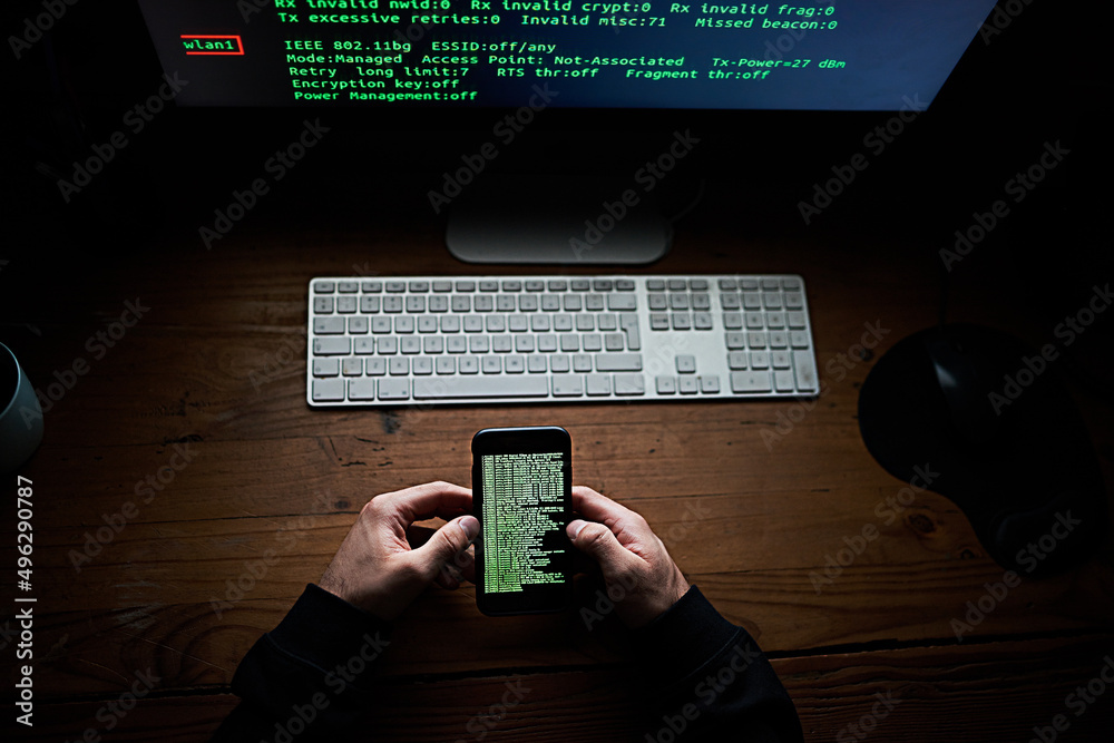 Poster not even your smartphone is safe. high angle shot of an unidentifiable hacker using a computer late 
