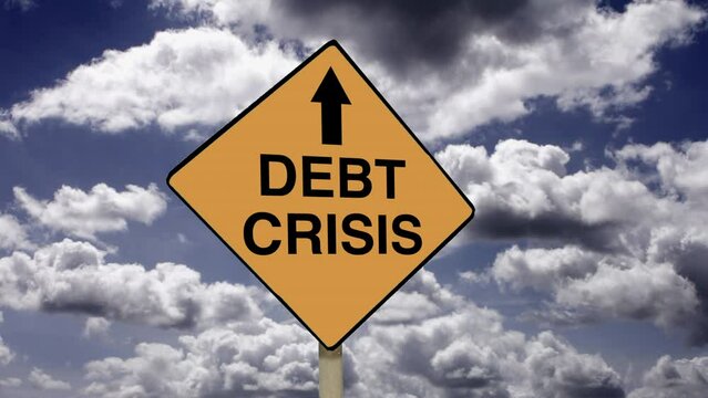 Money credit and financial problems. Zoom in to a Debt Crisis road sign with time lapse clouds background.