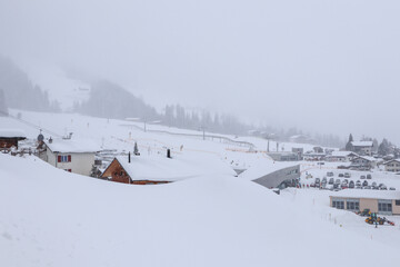 View to the Village of Churwalden, Switzerland, in foggy Wintertime