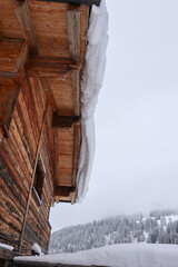 The roof of a chalet covered with lot of snow
