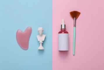 Venus bust and skin care products on a pink blue background. Skin care concept. Top view. Flat lay