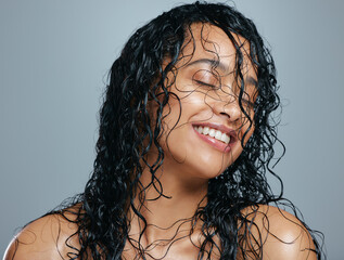 Keeping her mane a head about the rest. Studio shot of an attractive young woman posing with wet...