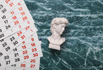 Paper Calendar with David bust on marble background