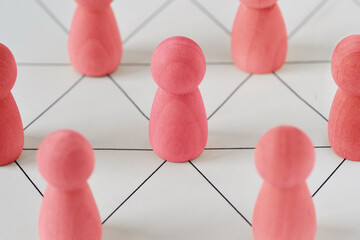Pink pawns connected together - Concept of woman and teamwork