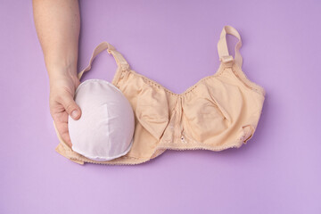 Breast prosthesis before inserting it into the special bra. Breast prosthesis and post surgery bra for breast cancer patient after mastectomy - obrazy, fototapety, plakaty