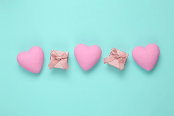 Fototapeta premium Gift boxes with hearts on a blue background. Love concept. Top view