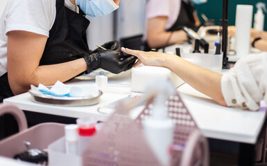 Manicurist workflow with client's nails. Nail care, manicure