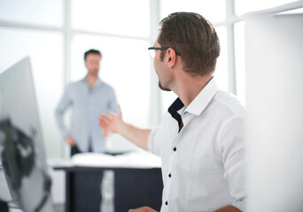 businessman talking with a colleague in the workplace