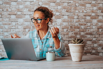 Hipter young woman talking in video call conference onine on laptop. People at work with computer....