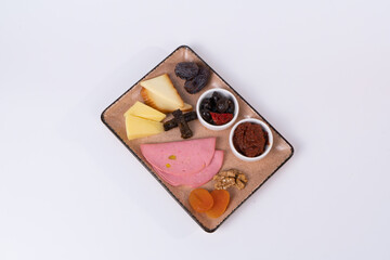 Image of tomato paste, olive, palm, ham, dried apricots, walnuts, wrapping in isolated environment in isolated environment in white background.