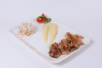 Opposite shot view of grilled chicken, mashed potatoes, salad and rice pilaf on isolated white background.