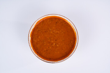 Cropped view of ezogelin soup shot from an overhead angle on an isolated white background.