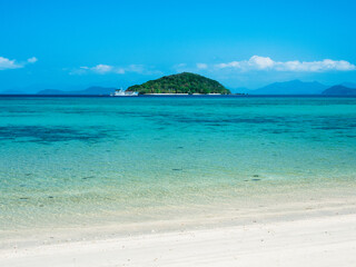 Scenic white sand beach tropical paradise island with crystal clear turquoise sea water and coral reef against blue sky in summer. Koh Mak Island, Trat, Thailand. Minimal background.