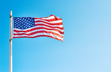 I pledge allegiance to the flag. Low angle shot of the American flag standing on its own outside during the day.