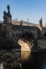 Beautiful view of the Charles Bridge in Prague, Czech Republic at the end of March. Cold sunny spring.