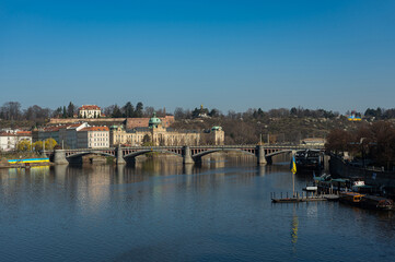 Prague, Czech Republic view of the Vltava river on the Manes bridge. The end of March. River banks in Ukrainian flags.