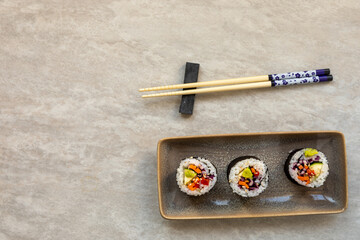 Vegan Futomaki (thick sushi rolls) with zucchini, celery stalks, carrot, red cabbage and red bell...