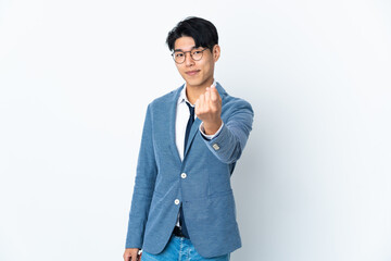 Fototapeta premium Young Chinese business man isolated on white background doing coming gesture
